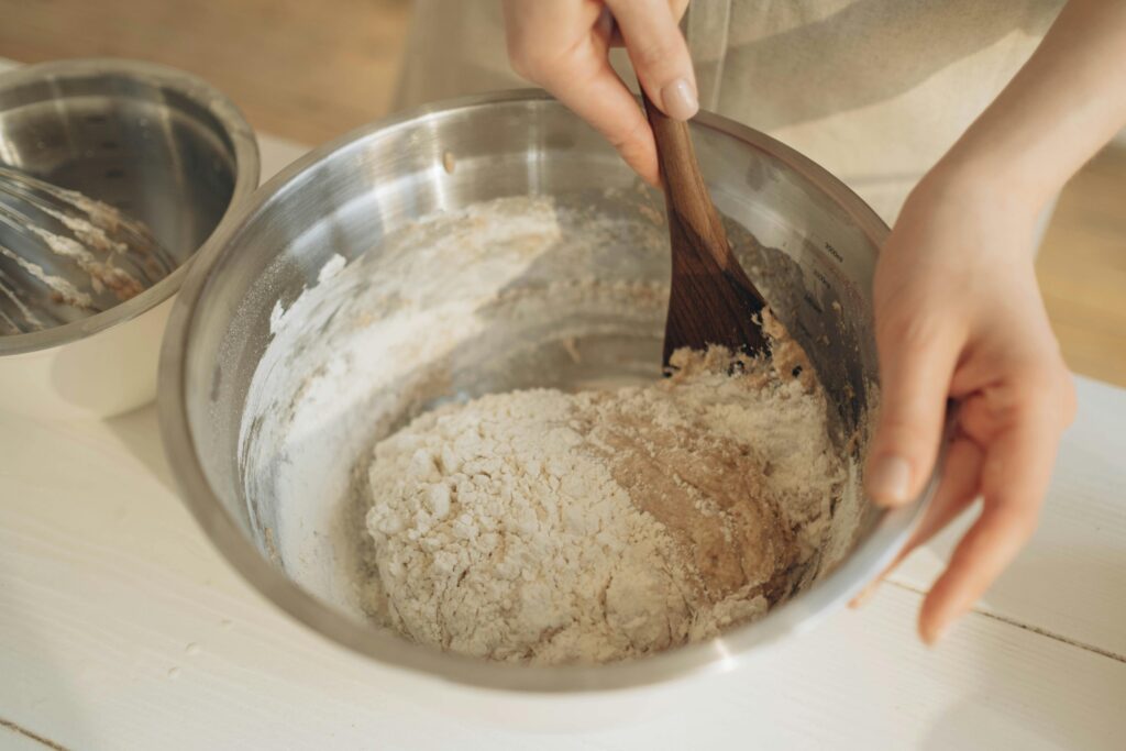 mixing a shaggy dough to make brioche burger buns with freshly milled flour