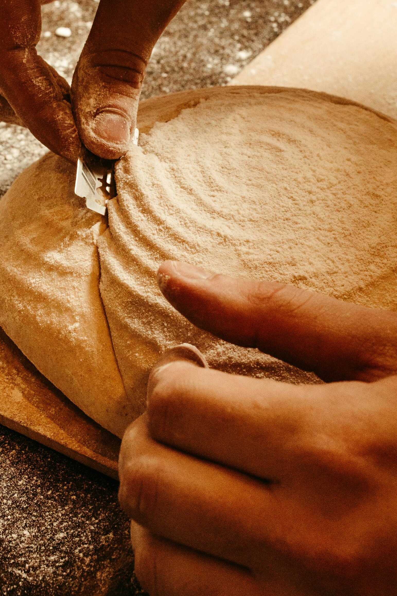 Scoring a freshly milled sourdough rustic loaf